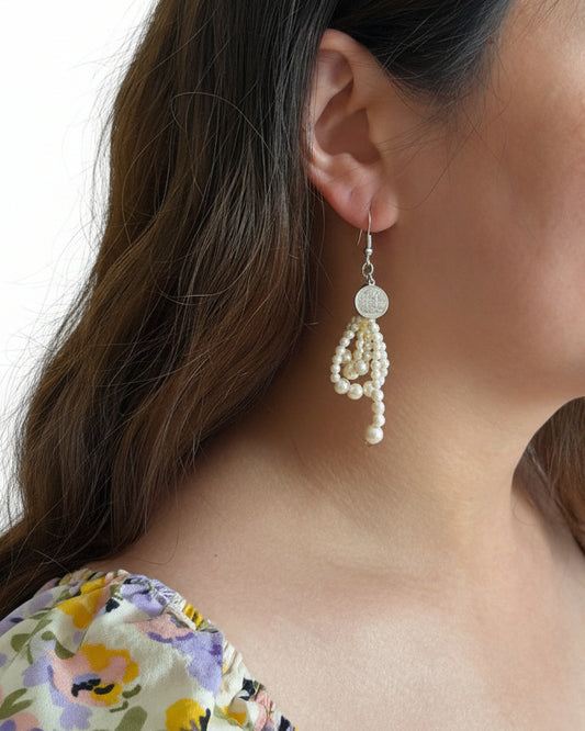Model wearing ivory faux pearl drop earrings with 925 silver hooks