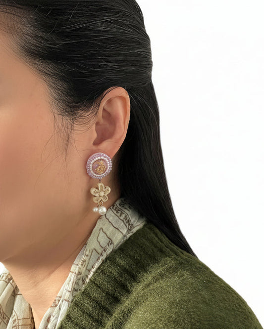Model wearing handmade Japanese floral pearl drop earrings with lavender and ivory detailing