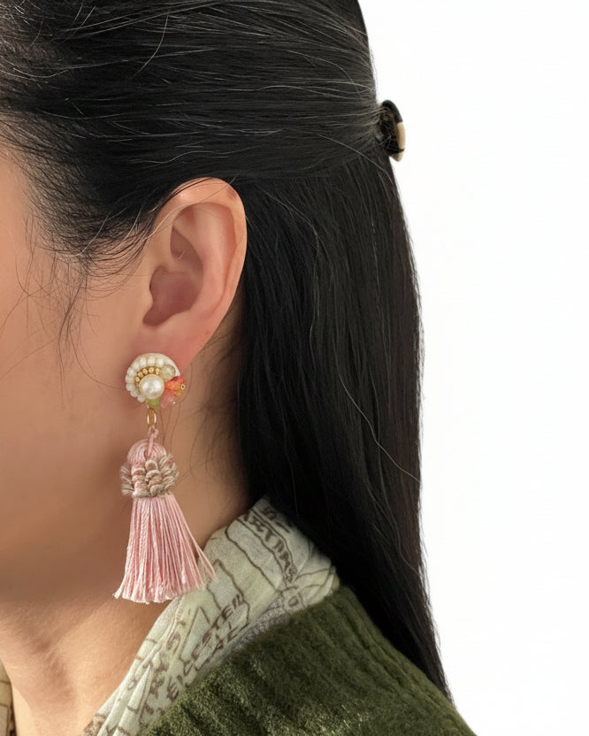 Model wearing handmade Japanese pearl beaded tassel earrings with soft pink tassels