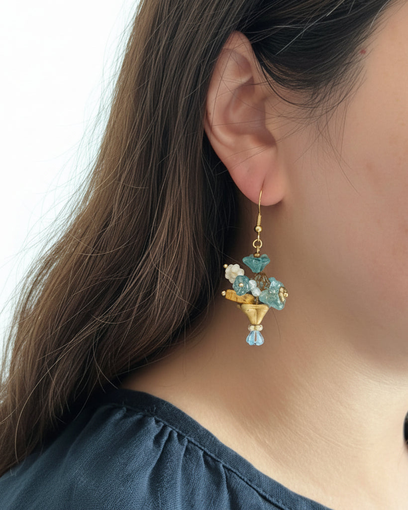 Model wearing bouquet earrings with blue and gold Czech bead detailing