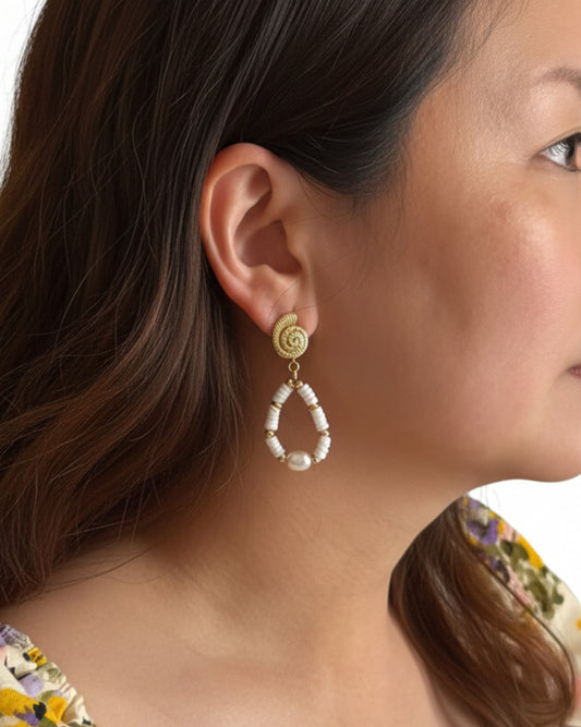 Model wearing white coral and freshwater pearl earrings in a refined seaside look