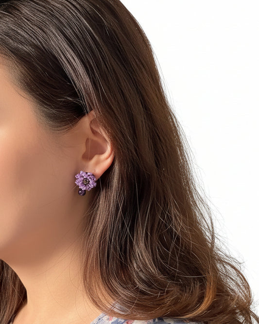 Model wearing handmade Japanese purple beaded flower earrings