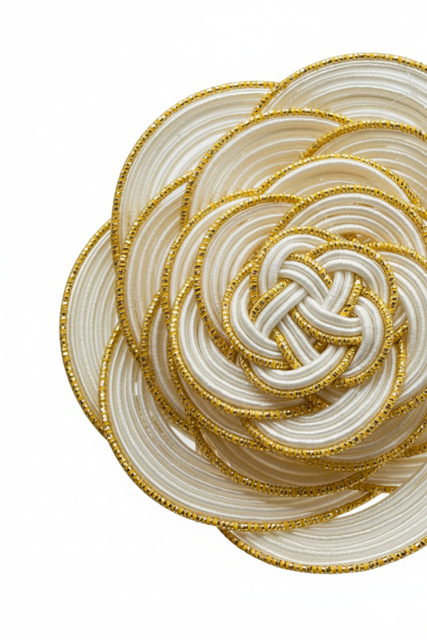Close-up of white and gold mizuhiki flower brooch