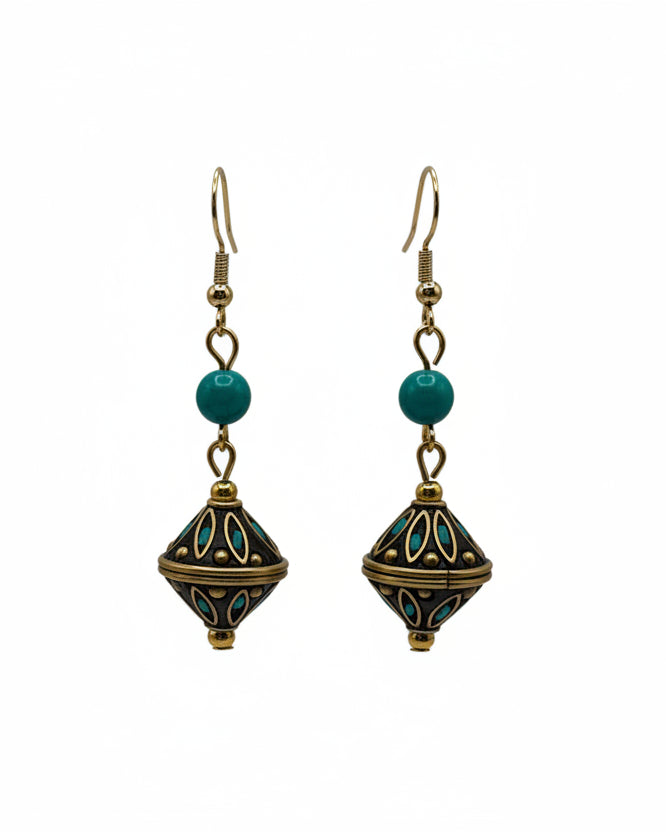 Pair of Nepal-inspired drop earrings with turquoise bead accents and ornate artisan bead detail