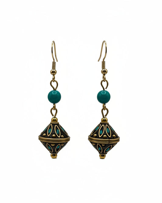 Pair of Nepal-inspired drop earrings with turquoise bead accents and ornate artisan bead detail